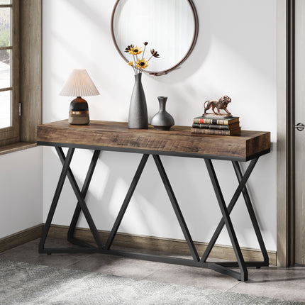 Industriële sidetable MEGIVEZ van 140 cm breed met bruin houten tafelblad van 10 cm dik, zwart geometrisch metalen onderstel, 30 cm diep en 90,5 cm hoog.