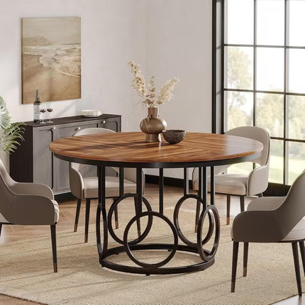 Ronde eettafel 120 cm met bruin houten tafelblad en zwart metalen onderstel met decoratieve ringen, vintage eetkamertafel voor 4 tot 6 personen op witte achtergrond.