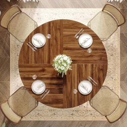 Ronde eettafel 120 cm met bruin houten tafelblad en zwart metalen onderstel met decoratieve ringen, vintage eetkamertafel voor 4 tot 6 personen op witte achtergrond.
