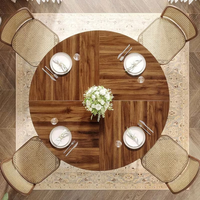 Ronde eettafel 120 cm met bruin houten tafelblad en zwart metalen onderstel met decoratieve ringen, vintage eetkamertafel voor 4 tot 6 personen op witte achtergrond.